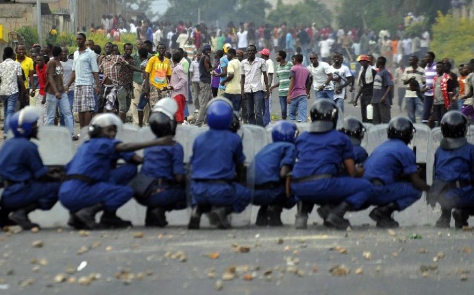 Burundian riot police form a barricade to hold protesters back during a demonstration against the president's bid to cling to power for a third term in Musaga, on the outskirts of the capital Bujumbura, in April.