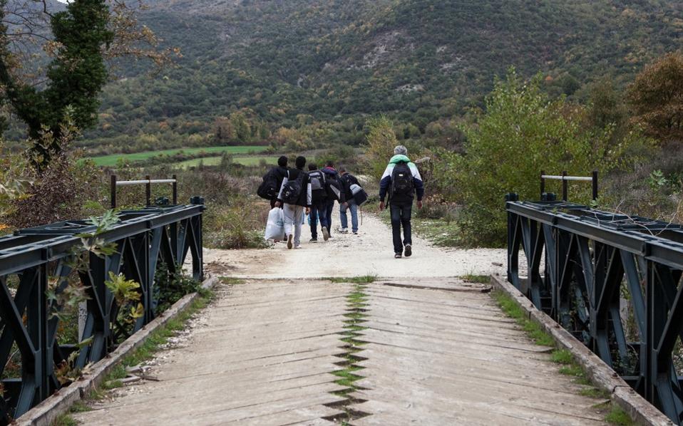 Syrian refugees cross a bridge in Gjirokaster, Albania, near the Kakavia border crossing from Greece, in a 2014 photograph.