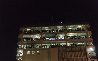 Ferry carrying refugees and migrants docks at Piraeus