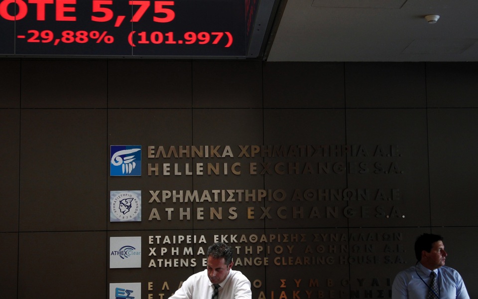 Greek stocks take historic beating as bourse reopens