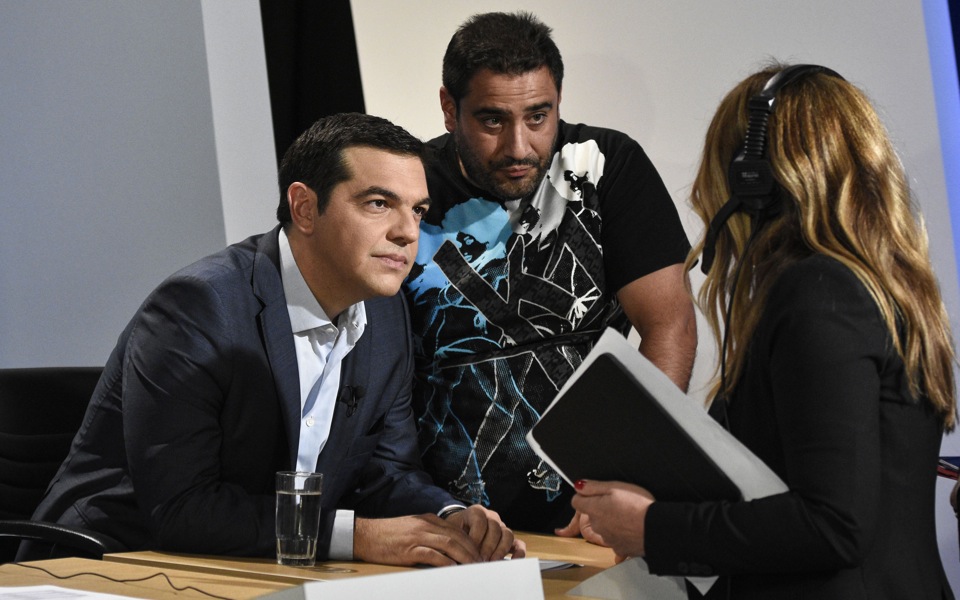 Tsipras defends record as opposition lashes out at him