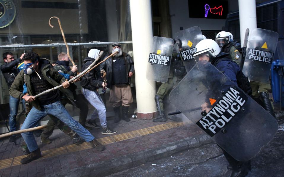 Greek farmers protesting tax hikes fight police in Athens