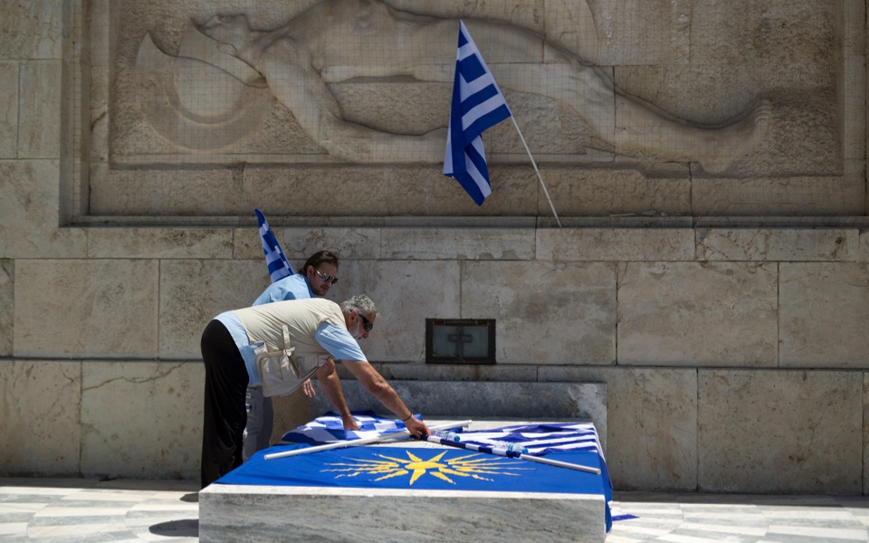 Protesters lay flags during rally against Athens-Skopje name deal