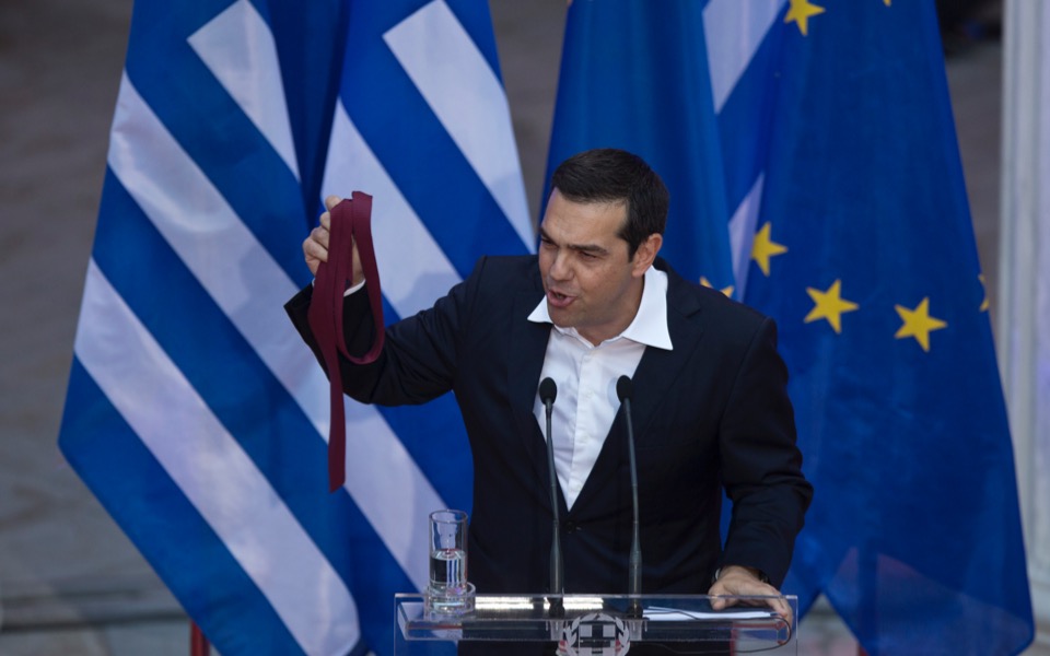 Tsipras marks agreement on Greek debt with red tie