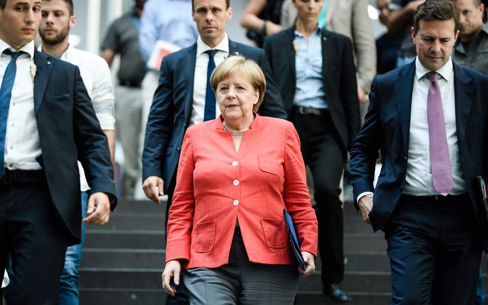 Merkel defends Greek primary surplus targets