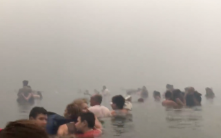 Video shows people swimming out to sea to escape blaze