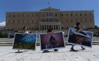 Crews set up large-size prints for Athens Photo World