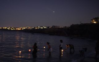 In Greece, floating candles mark anniversary of deadly fire