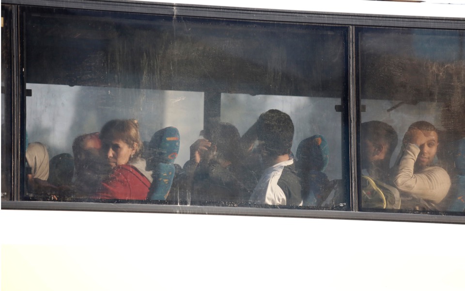 Migrants and refugees transferred to camps after squat raids