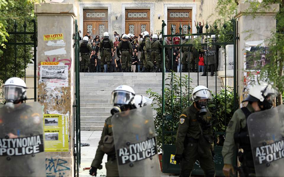 Police clash with youths outside Athens business school