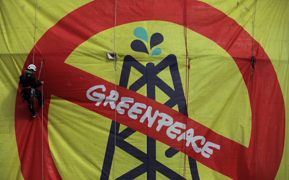 Greenpeace activists abseil down HELPE storage tank to protest ‘climate emergency’