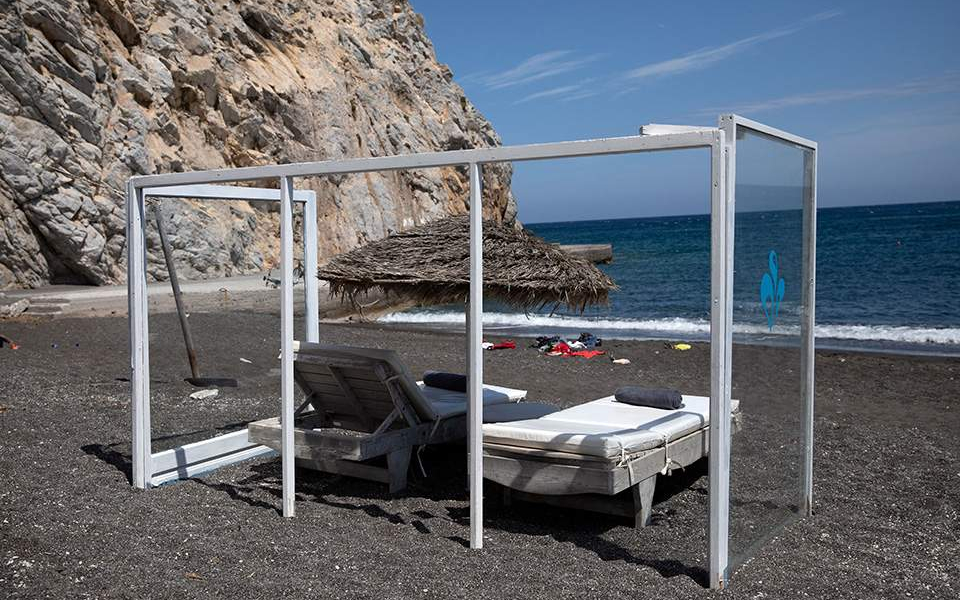 With plexiglass barriers, Santorini island wants visitors to return
