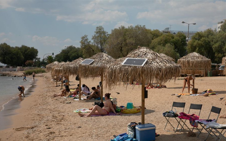 Athens beachgoers use sun to charge devices