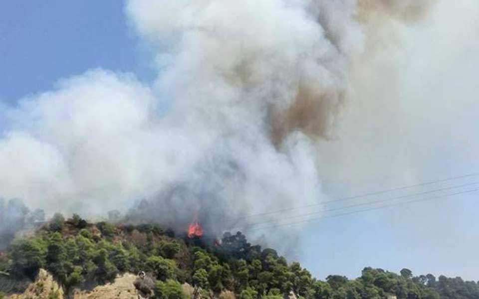 Village evacuated as firefighters battle blaze