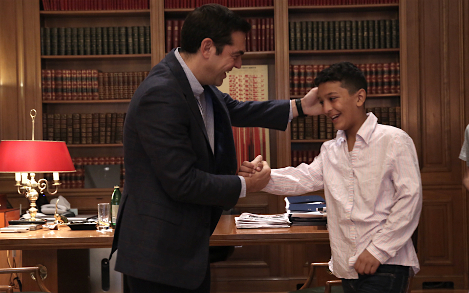 Greek PM hosts Afghan boy, 11, whose home was targeted by racist vandals
