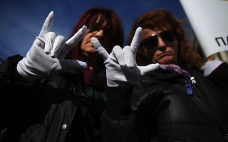 Deaf protesters make victory sign at anti-austerity rally