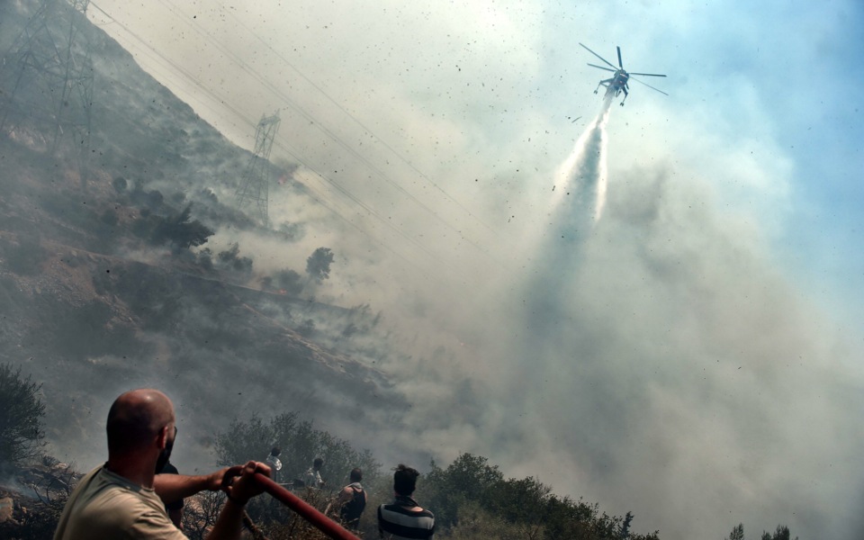 Greek firefighters battle blazes; save 200 trapped on beach