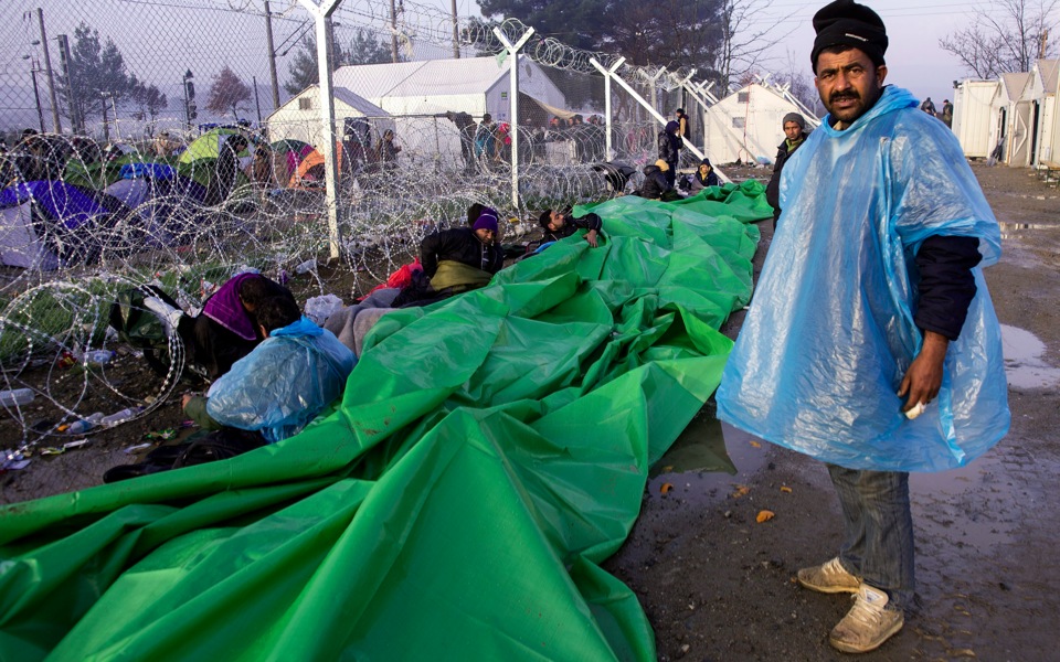 Mud-soaked migrants fight for food as border blockade drags on