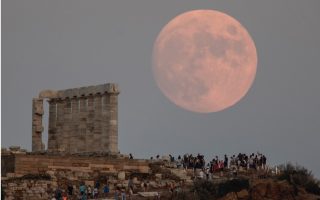 Moon rises behind Temple of Poseidon