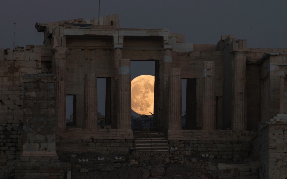 Moon rises behind ancient citadel