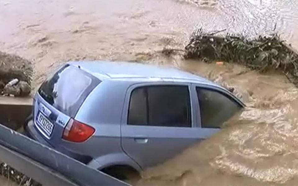 Downpour near Athens floods roads, traps residents