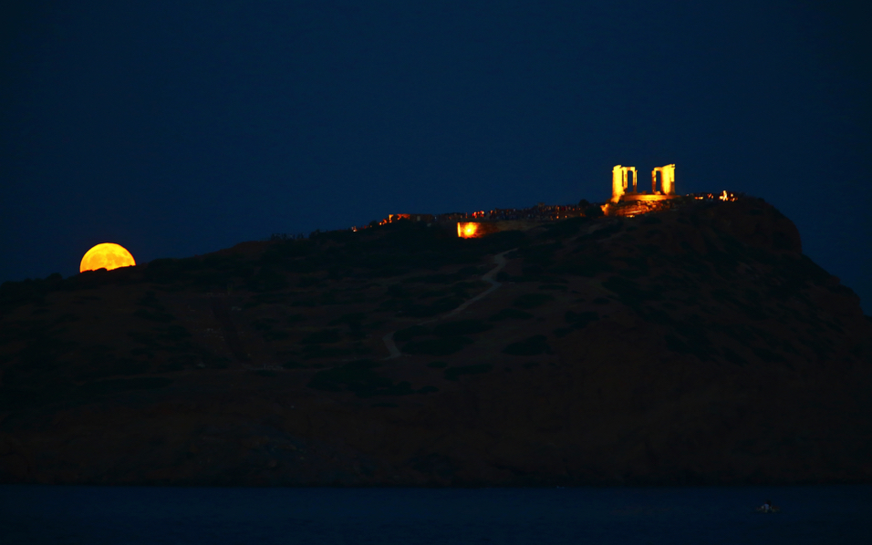 Moon rises behind cape of Sounio