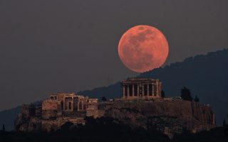 Super moon rises over temple of Apollo