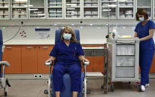 A nurse is first to be vaccinated against Covid-19 in Greece