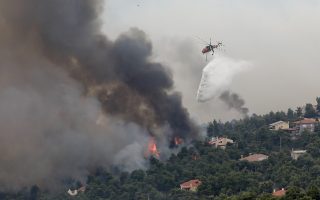 More people evacuated in northern Athens; fire threatens power facilities, shuts highway