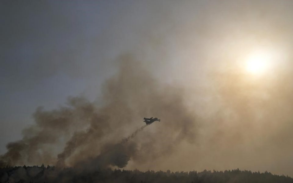 Crews race to contain fire near Athens after thousands flee