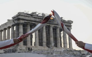 Olympic flame changes hands in front of the Parthenon