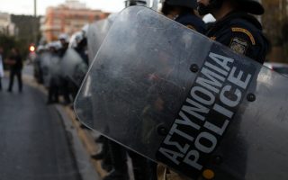 Riot police clash with football hooligans in central Athens