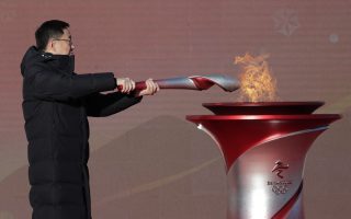Torch begins Covid-shortened trek past Beijing landmarks