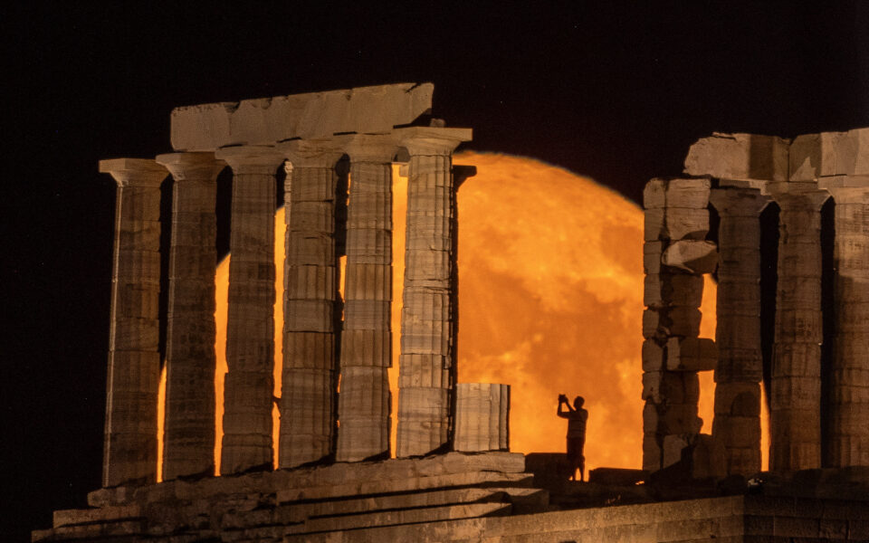 Buck Moon rises behind the Temple of Poseidon