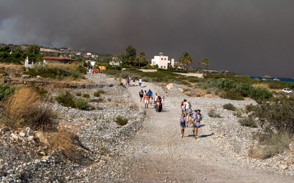 A wildfire is raging out of control on Rhodes, forcing tourist evacuations