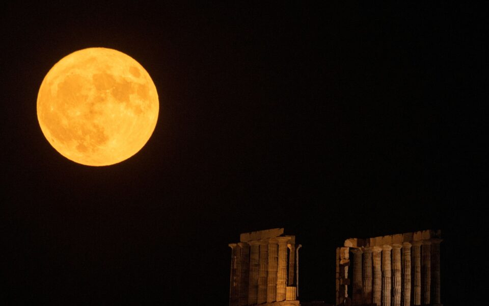 Full moon rises behind the Temple of Poseidon in Cape Sounion