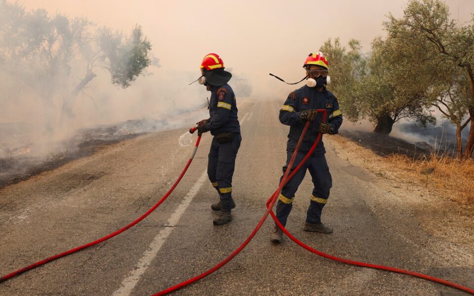 Firefighters stop wildfire at the perimeter of Elefsina Air Base
