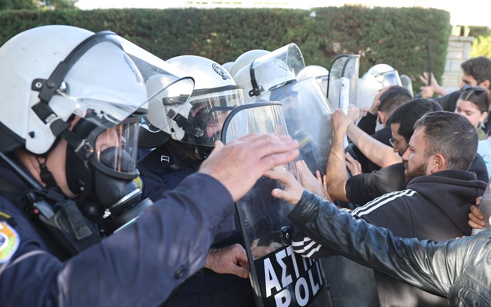 Students clash with police outside meeting of deans